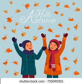 Happy kids having fun and playing with autumn leaves in park. Autumn landscape background