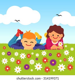 Happy kids laying on the meadow grass full of field flowers. Youth innocent platonic love. Young couple. Vector flat style isolated cartoon illustration.