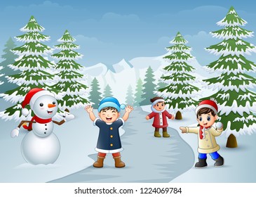 Happy kids playing with a snowman in winter