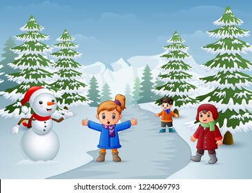Happy kids playing with a snowman in winter
