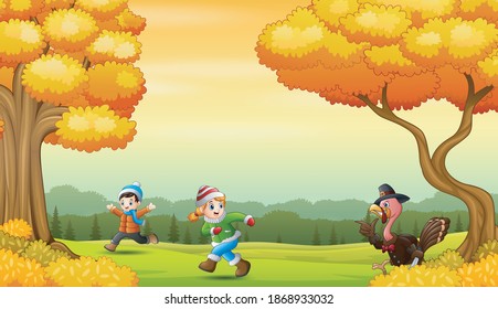 Happy kids playing with turkey bird in the autumn landscape