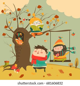 Happy kids ride on a swing in the autumn forest