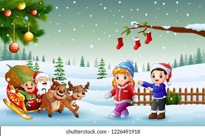 Happy kids and santa claus with elf riding on a sleigh with bag of gifts pulled by reindeer