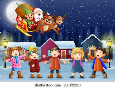 Happy kids singing with santa claus and elf riding his sleigh at the winter night
