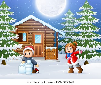 Happy kids to wear winter clothes and play in front of a snowy wooden house