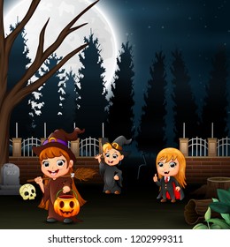 Happy kids wearing a halloween costume in the full moon background