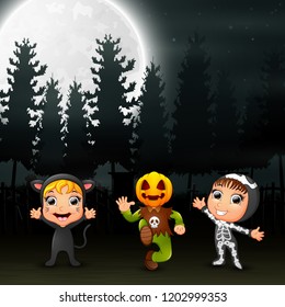 Happy kids wearing halloween costume in the garden at night