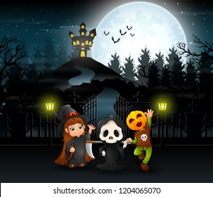 Happy kids wearing halloween costume outdoors with the haunted house background