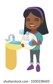 Happy little african girl washing dishes in the sink. Smiling girl doing dishes and having fun with helping her parents with housework. Vector sketch cartoon illustration isolated on white background.