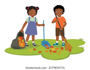 Happy little African kids boy and girl raking fallen autumn leaves into plastic bag cleaning up in the garden 