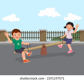 Happy little boy and girl kids playing swinging on seesaw in the park