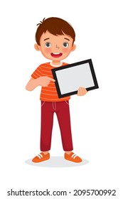 Happy little boy holding digital tablet with finger pointing to empty screen or copy space for texts, messages and advertising content. Kids and electronic gadget devices concept for children.

