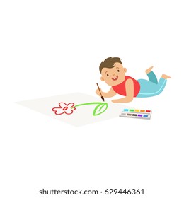 Happy little boy lying on the floor and drawing on big paper. Colorful character vector Illustration