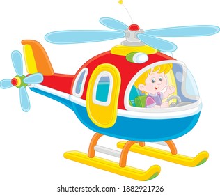 Happy little boy playing and piloting a big and colorful toy helicopter on a playground, vector cartoon illustration on a white background