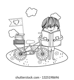 happy little boy reading book with bicycle in the field