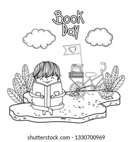 happy little boy reading book with bicycle in the field