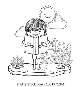 happy little boy reading book in the garden