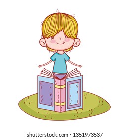 happy little boy reading book in the landscape
