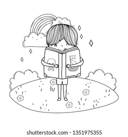 happy little boy reading book in the landscape