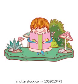 happy little boy reading book in the garden