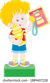 Happy little champion holding a gold medal and a prize cup of a winner and standing on a podium of competitions at an award ceremony, vector cartoon illustration isolated on a white background