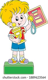 Happy little champion holding a gold medal and a prize cup of a winner and standing on a podium of competitions at an award ceremony, vector cartoon illustration isolated on a white background