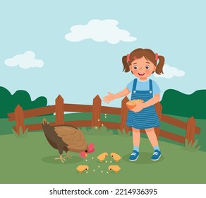 niña feliz alimentando pollos en la granja 