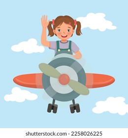 happy little girl flying an airplane waving hand in the blue sky