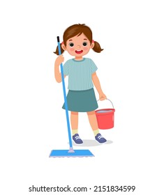 Happy little girl holding mop and bucket cleaning floor doing housework chore