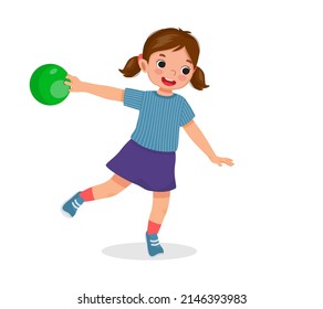 happy little girl playing bowling in the sport club ready to throw the ball