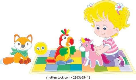 Happy little girl playing with a funny soft toy unicorn, a parrot and a fox on a colorful checkered carpet in a nursery, vector cartoon illustration isolated on a white background