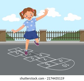 happy little girl playing hopscotch drawn with chalk outside on playground street at the park