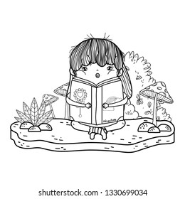 happy little girl reading book in the garden