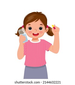 happy little girl taking medicine capsule with a glass of water