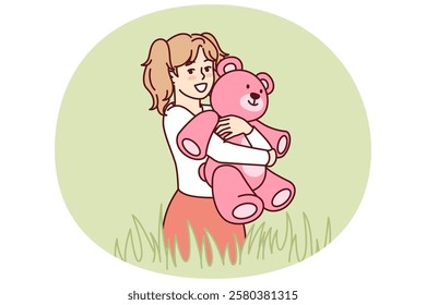 Happy little girl with teddy bear in hands stands in meadow among tall grass and looks at screen. Child with smile hugs beloved toy bear, presented for birthday, during summer walk