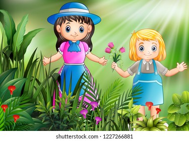 Happy little girls picking a flowers in the garden