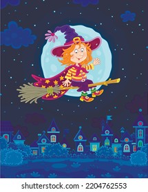 Happy little Halloween witch with a big hat flying on her magic broom over a pretty small town on a mysterious moonlit night, vector cartoon illustration