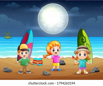 Happy little kids playing on the beach at night