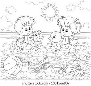 Happy little kids swimming in inflatable rings on a sea beach on a sunny summer day, black and white vector illustration in a cartoon style for a coloring book