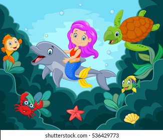 Happy little mermaid playing in the ocean