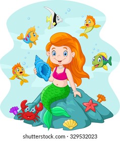 Happy little mermaid sitting on the rock surrounded by fishes