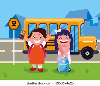 happy little school girls in the bus stop