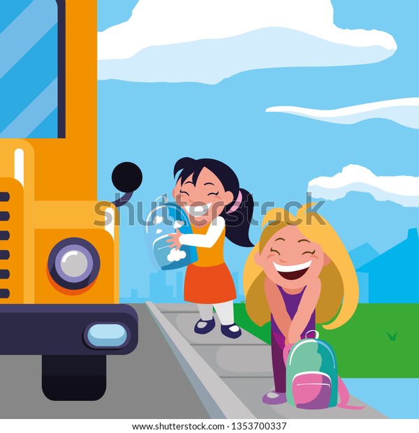 happy little school\
girls in the bus stop