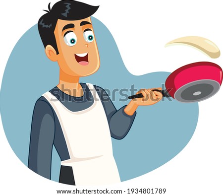 Happy Man Flipping Pancakes Making Breakfast. Young guy cooking dessert meal having fun
