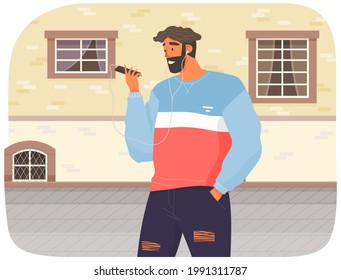 Happy man with headphones is looking at his smartphone. Guy listens to music while walking. Person in headphones connected to phone listening to songs. Male character uses technology outdoor
