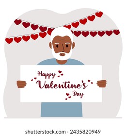 Happy man holding a poster with text Happy Valentine's Day and red hearts. Love concept. Happy Valentine's Day wallpaper, poster, postcard or congratulation.