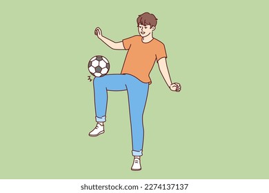 Happy man kicking soccer ball wanting to become famous major league player and compete in international sports competitions. Young promising soccer player training alone with smile doing tricks 
