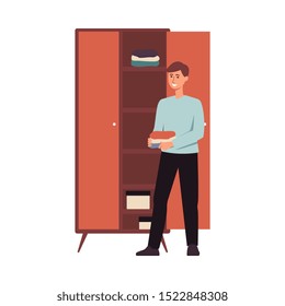 Happy man organising clothes in a closet, young male cartoon character standing beside wardrobe with folded shirts, housework and home cleaning process - isolated flat vector illustration