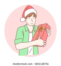 Happy man with Santa hat holding gift box. Hand drawn flat character style.