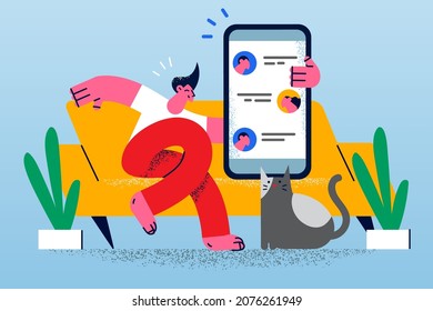 Happy man sit on sofa relax at home use cellphone text message online with friends. Smiling guy rest indoors communicate chat on smartphone. Communication, technology. Vector illustration. 